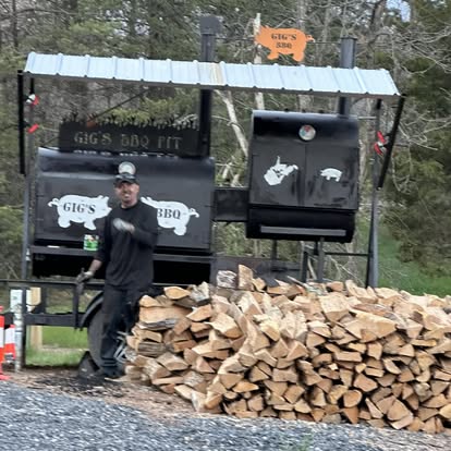 Seasoned firewood stacked for the smoker